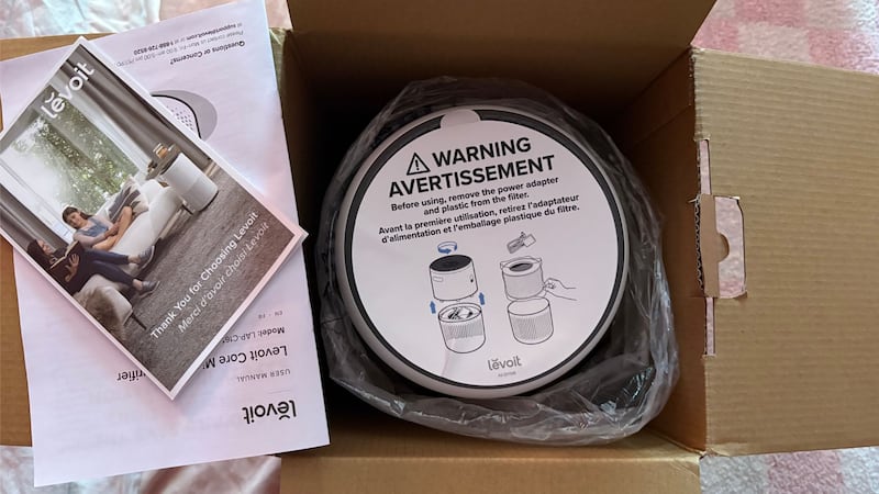 The air purifier in it's box with instruction books