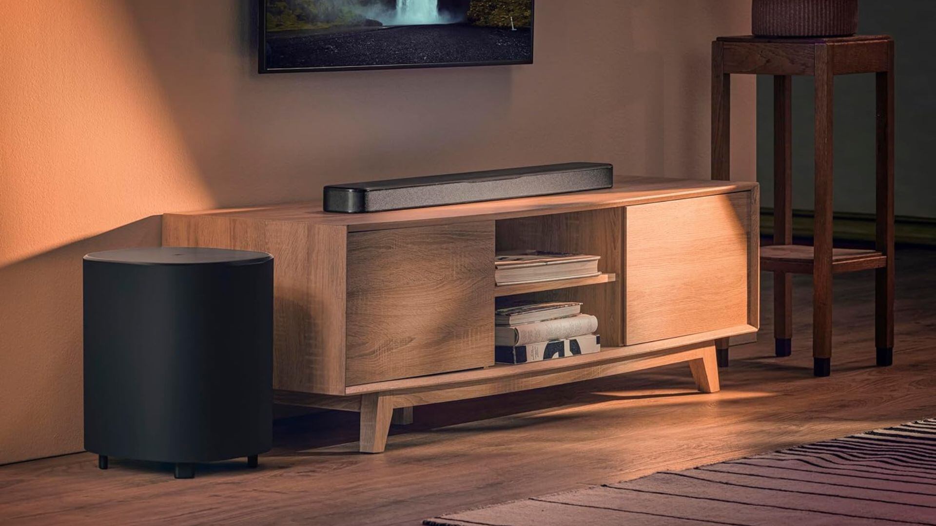 A JBL soundbar on a media console.