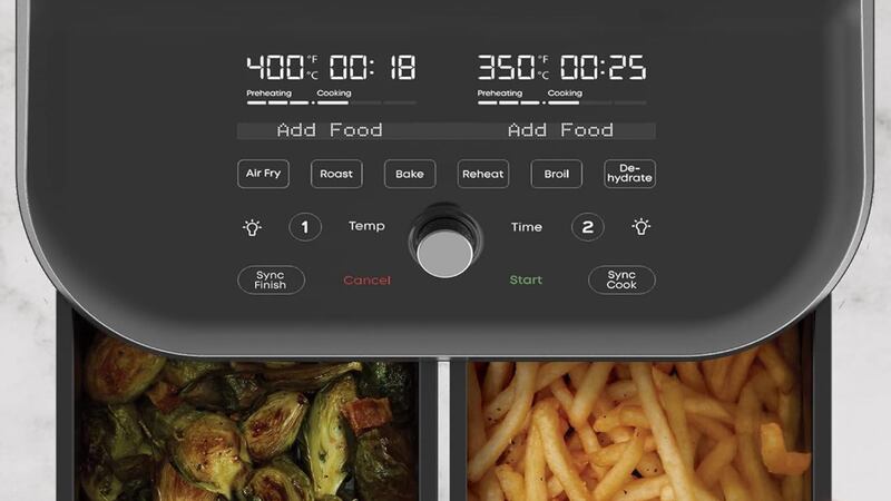 Presets on an air fryer. Brussels sprouts and fries are in the baskets.