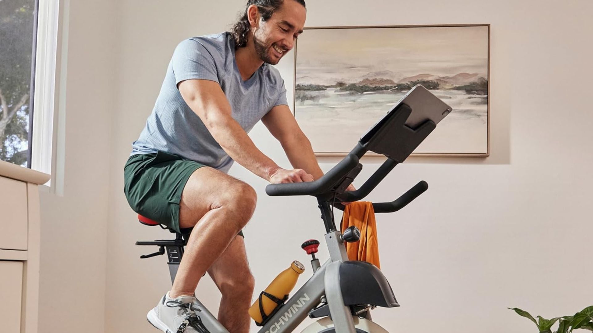A person riding on an exercise bike at home.