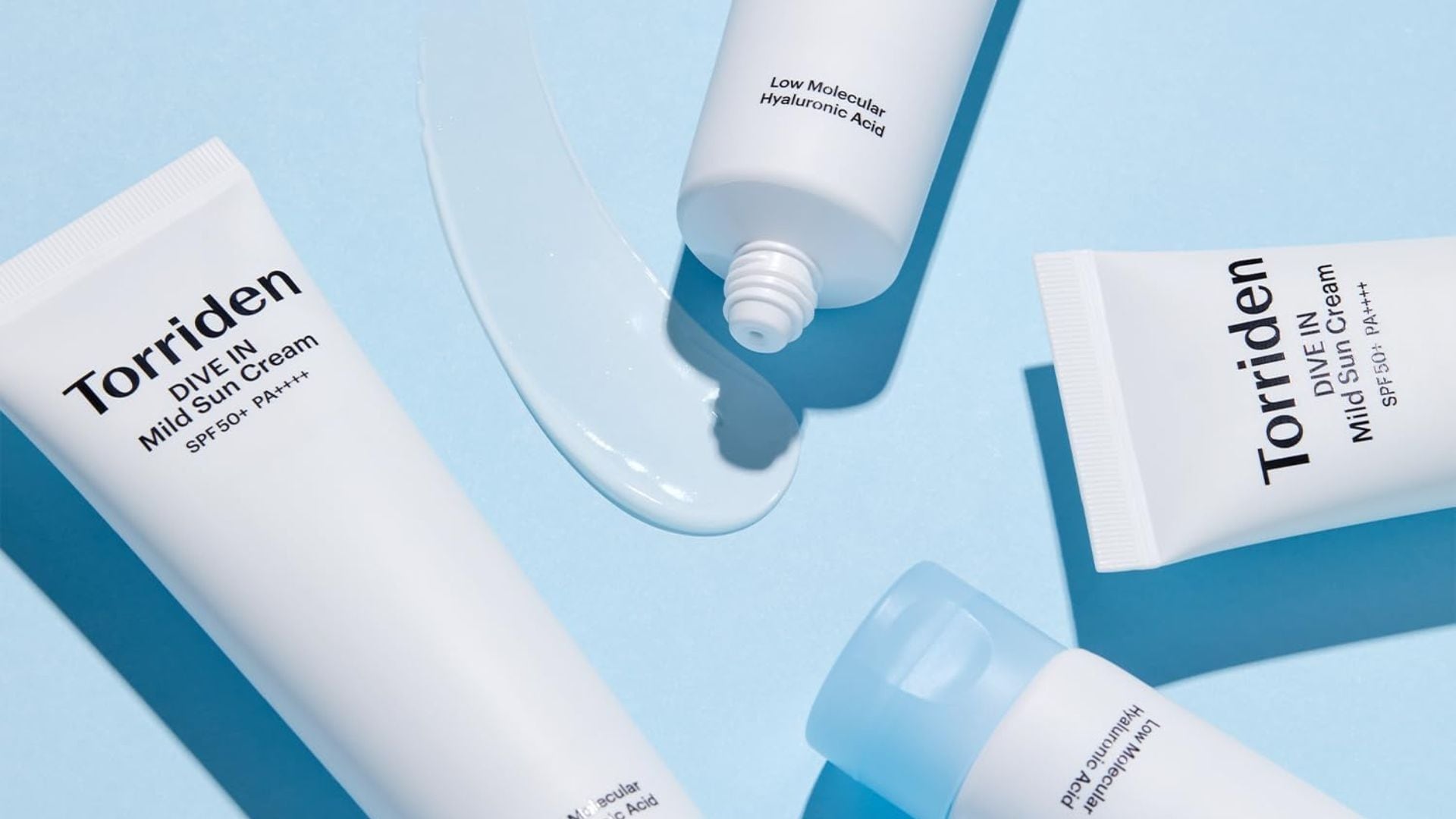 four tubes of sunscreen with a bright background