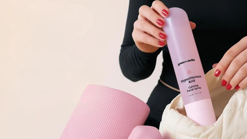 A model reaching for the facial spray in their gym bag with a bright background