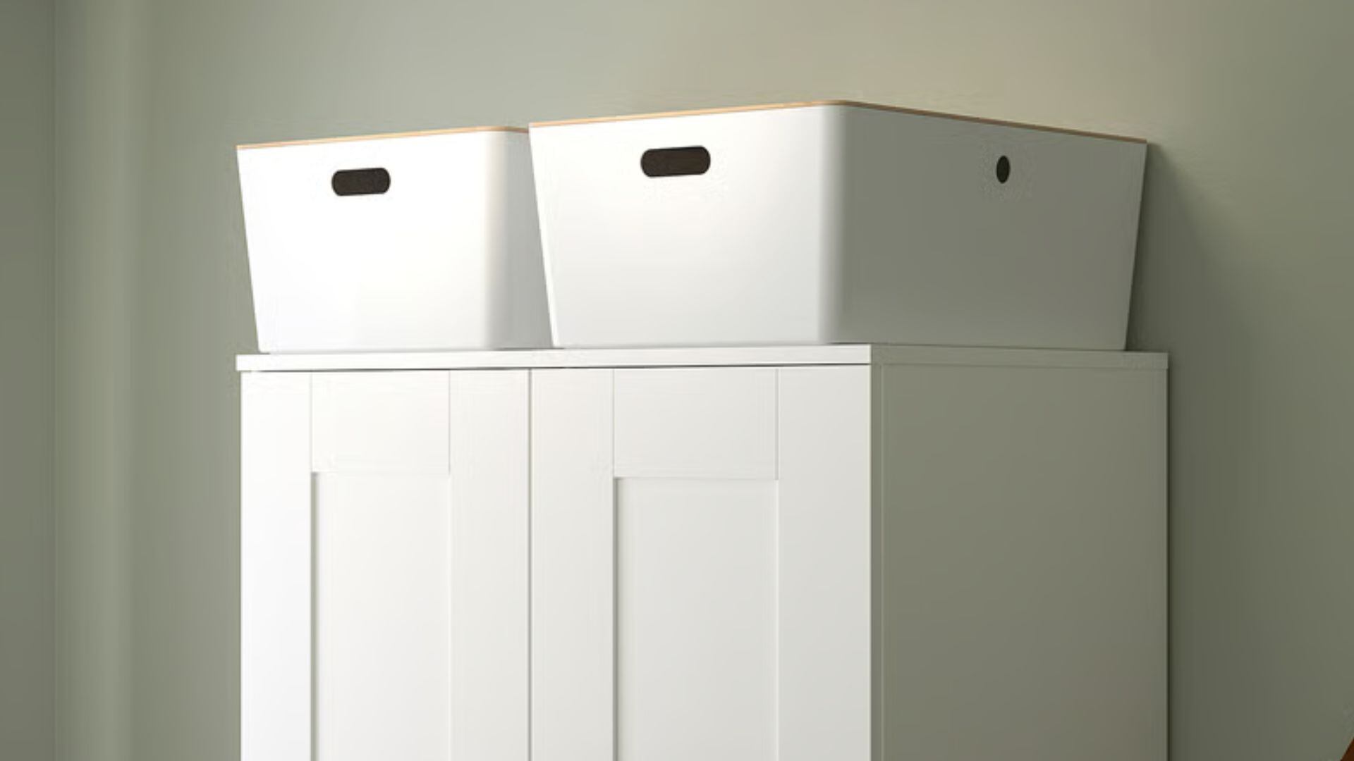 Two bins on top of a wardrobe.