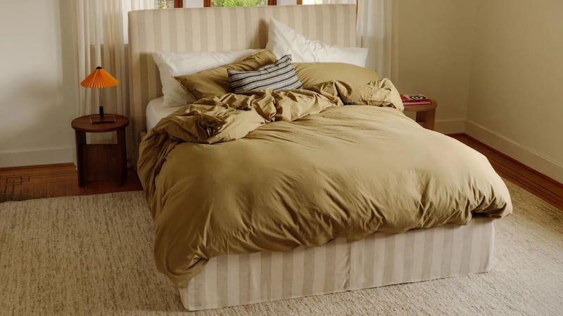 a bed in a bedroom with a fluffy duvet on it