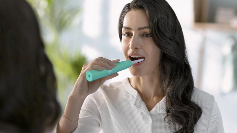 A person brushing their teeth.