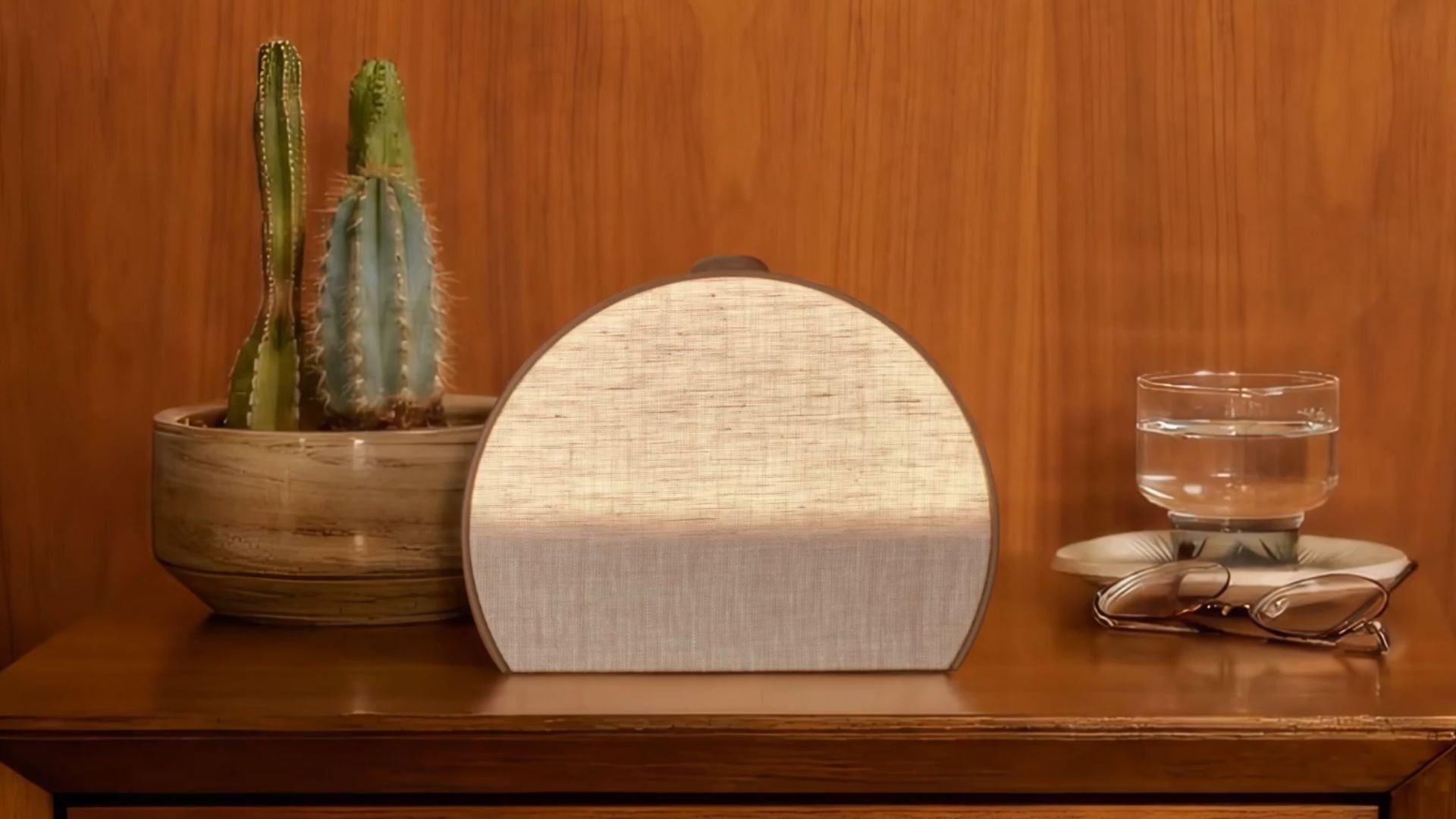 A Hatch Restore 3 on a nightstand with a cactus, water, and glasses.