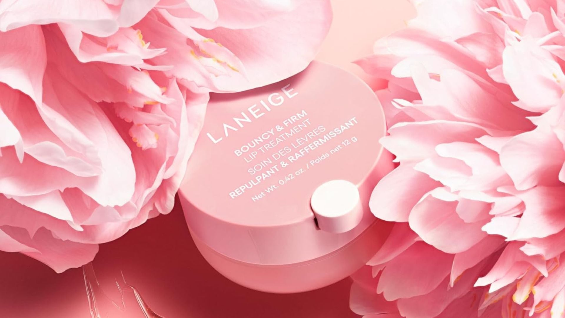 A Laneige lip treatment surrounded by flowers.