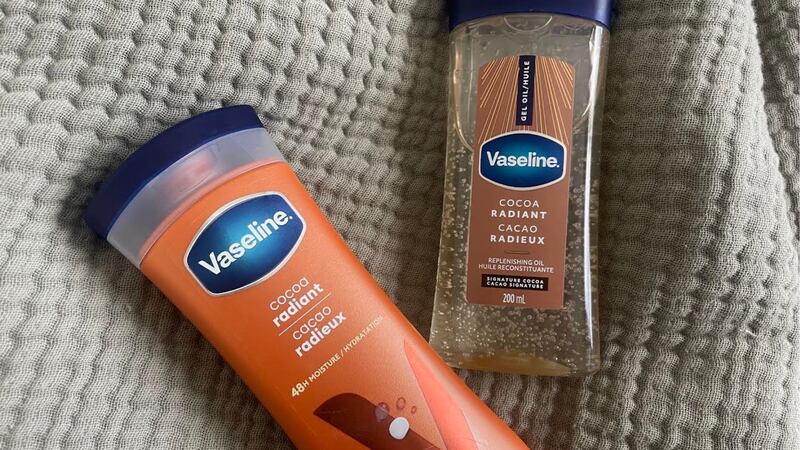 Two Vaseline lotions on a bed.