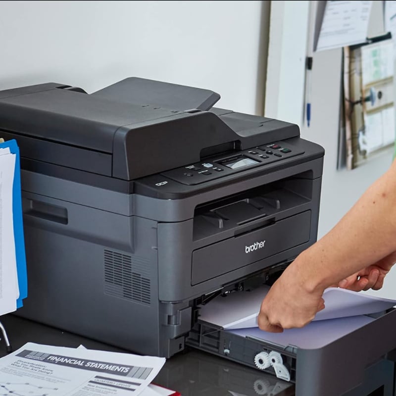 a person loading the paper tray