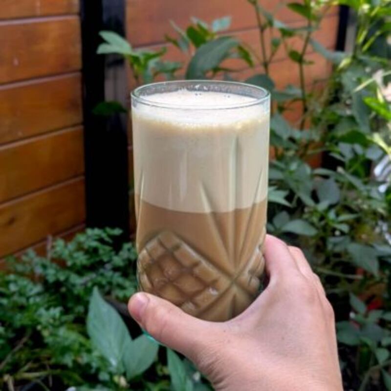 Lysandre Dolbec holding a glass of homemade coffee