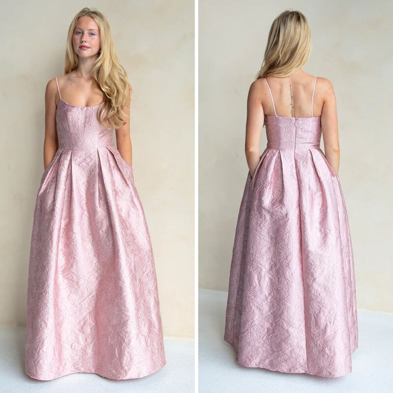 A person wearing a blush pink gown from Fitzroy Rentals.