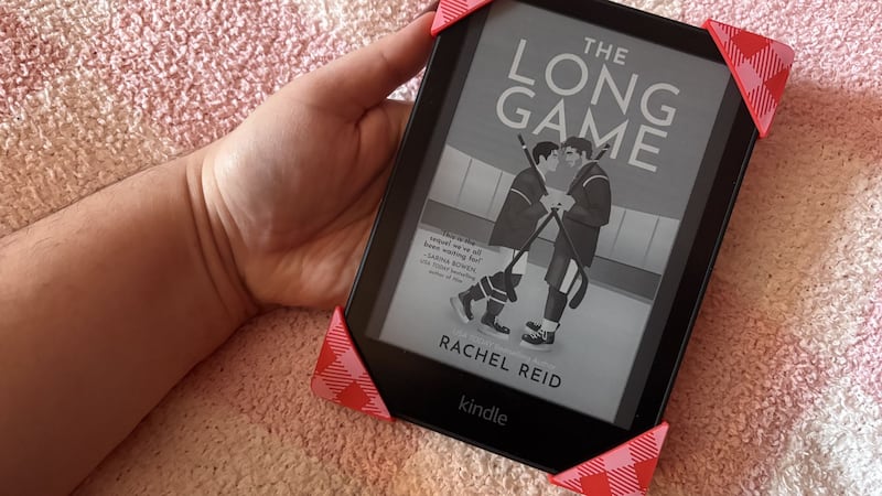 Bianca holding her Kindle with the Strapcicle on it