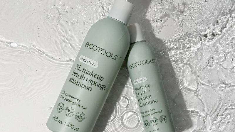 Two bottles of brush shampoo/cleanser in water.