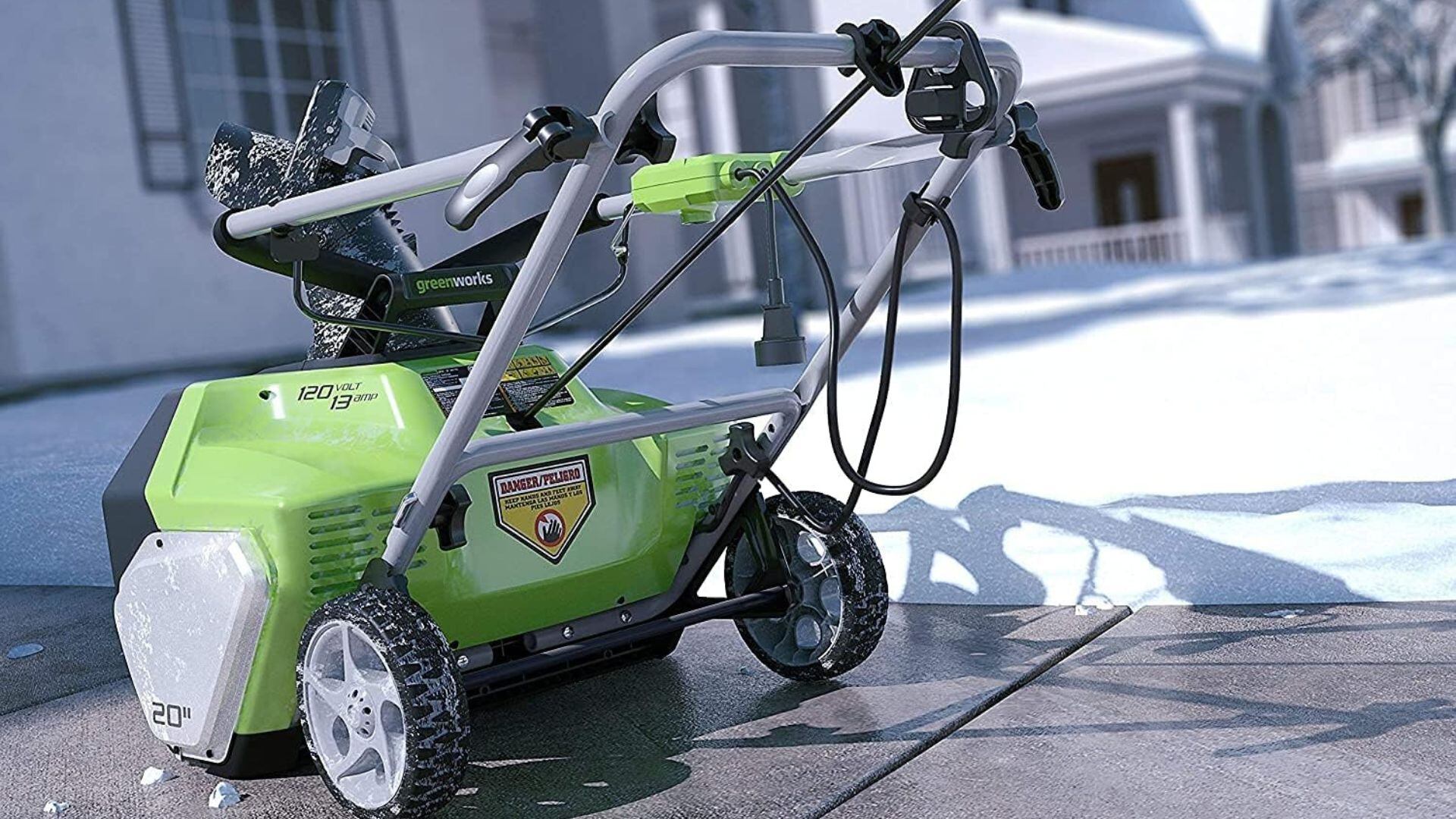 A snow blower in a driveway.