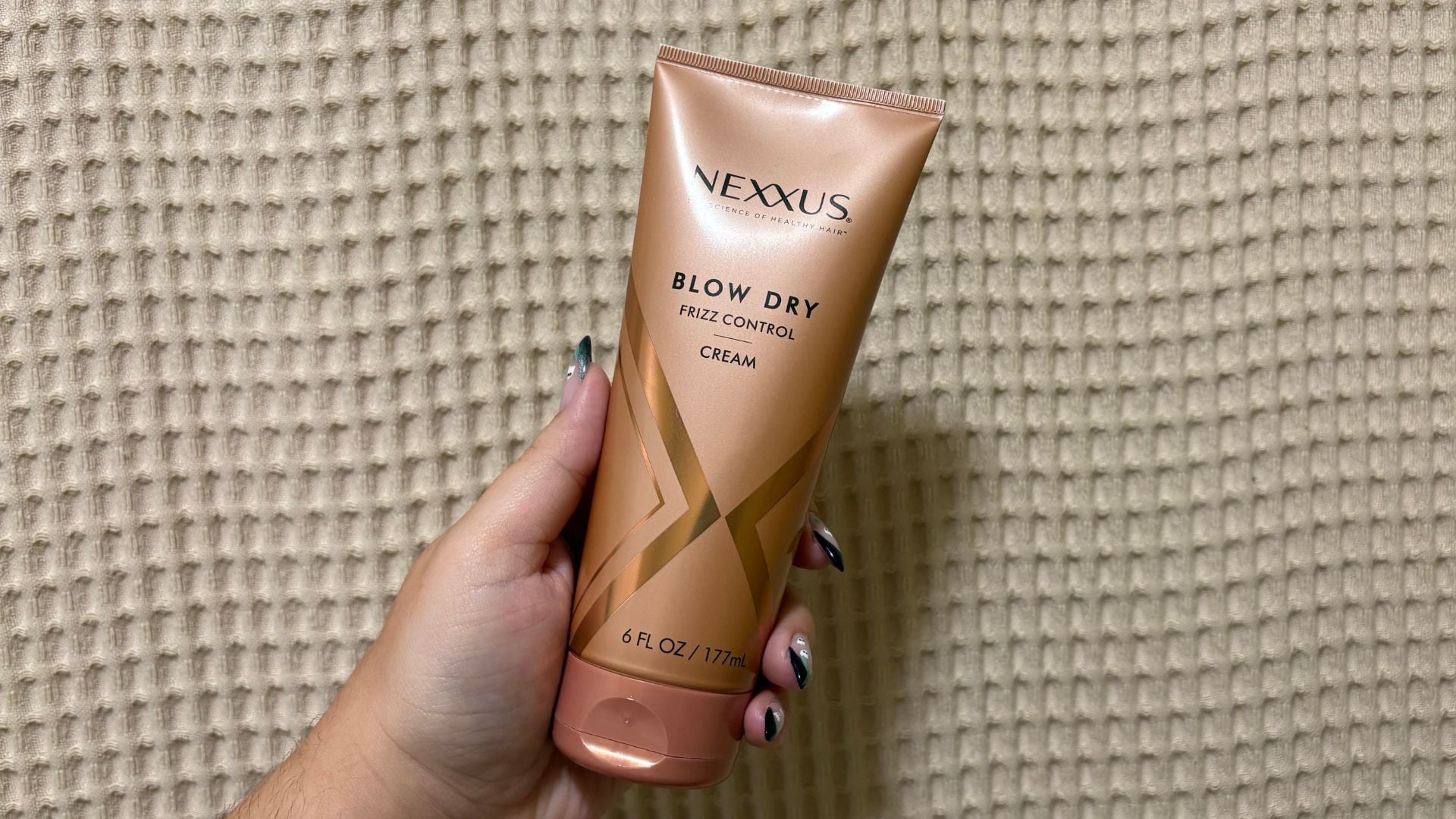 Bianca holding up the blow dry cream