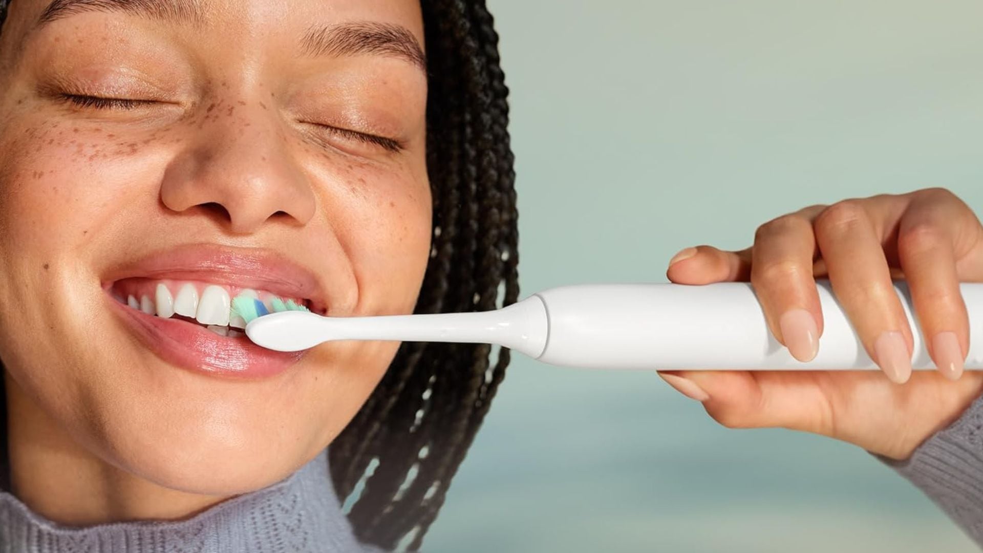 A person brushing their teeth.
