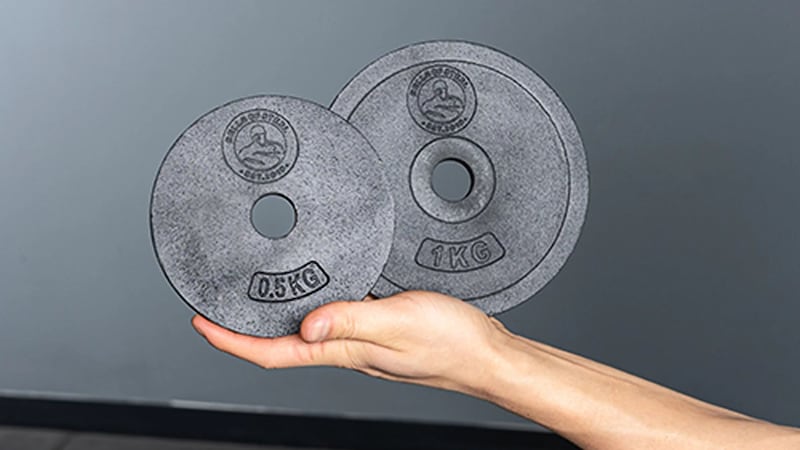 A persobn holding kettlebell plates