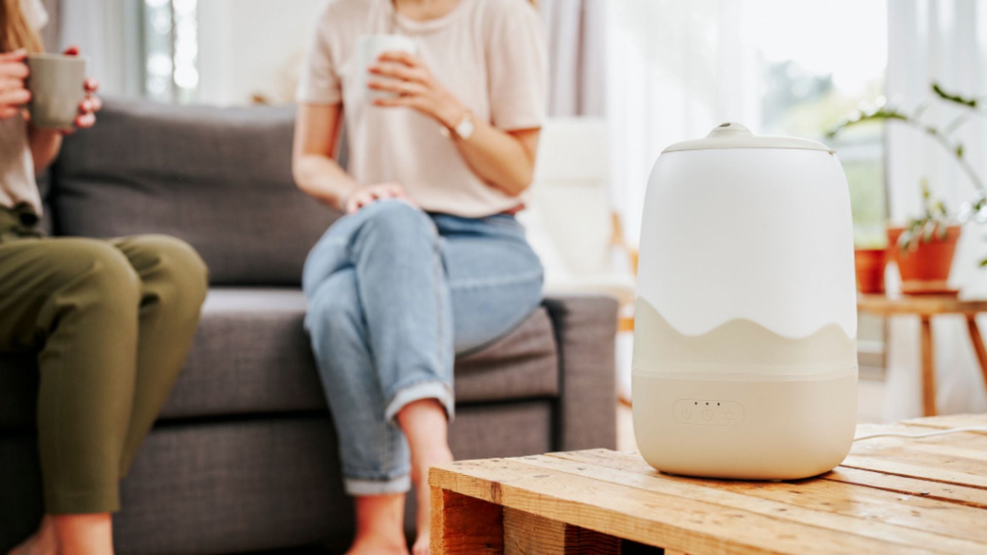A Babymoov Wave 3-in-1 Baby Humidifier on a coffee table.