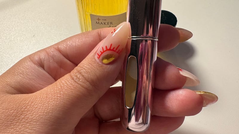 Bianca holding the atomizer full of perfume