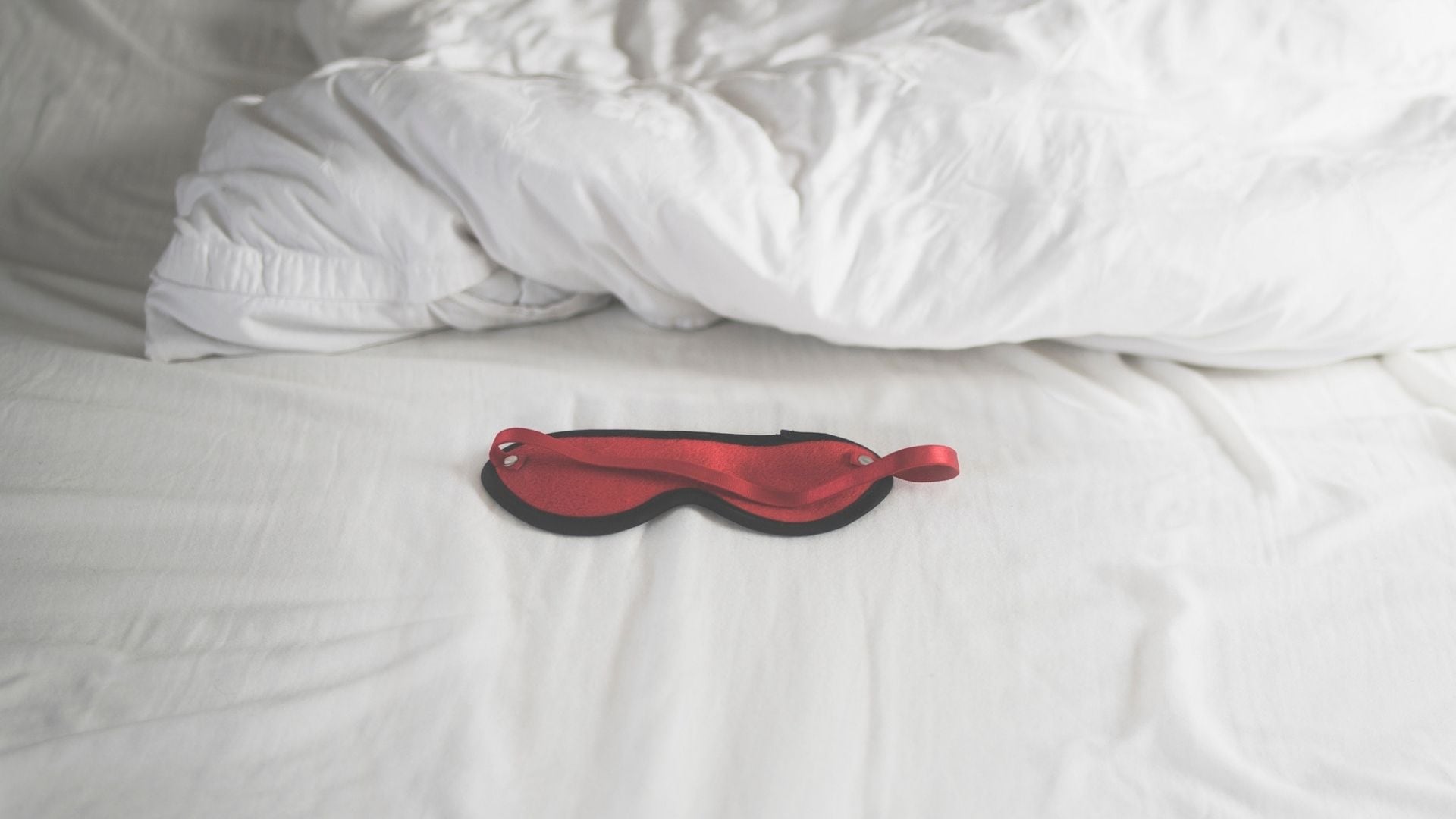 A silk mask on a bed