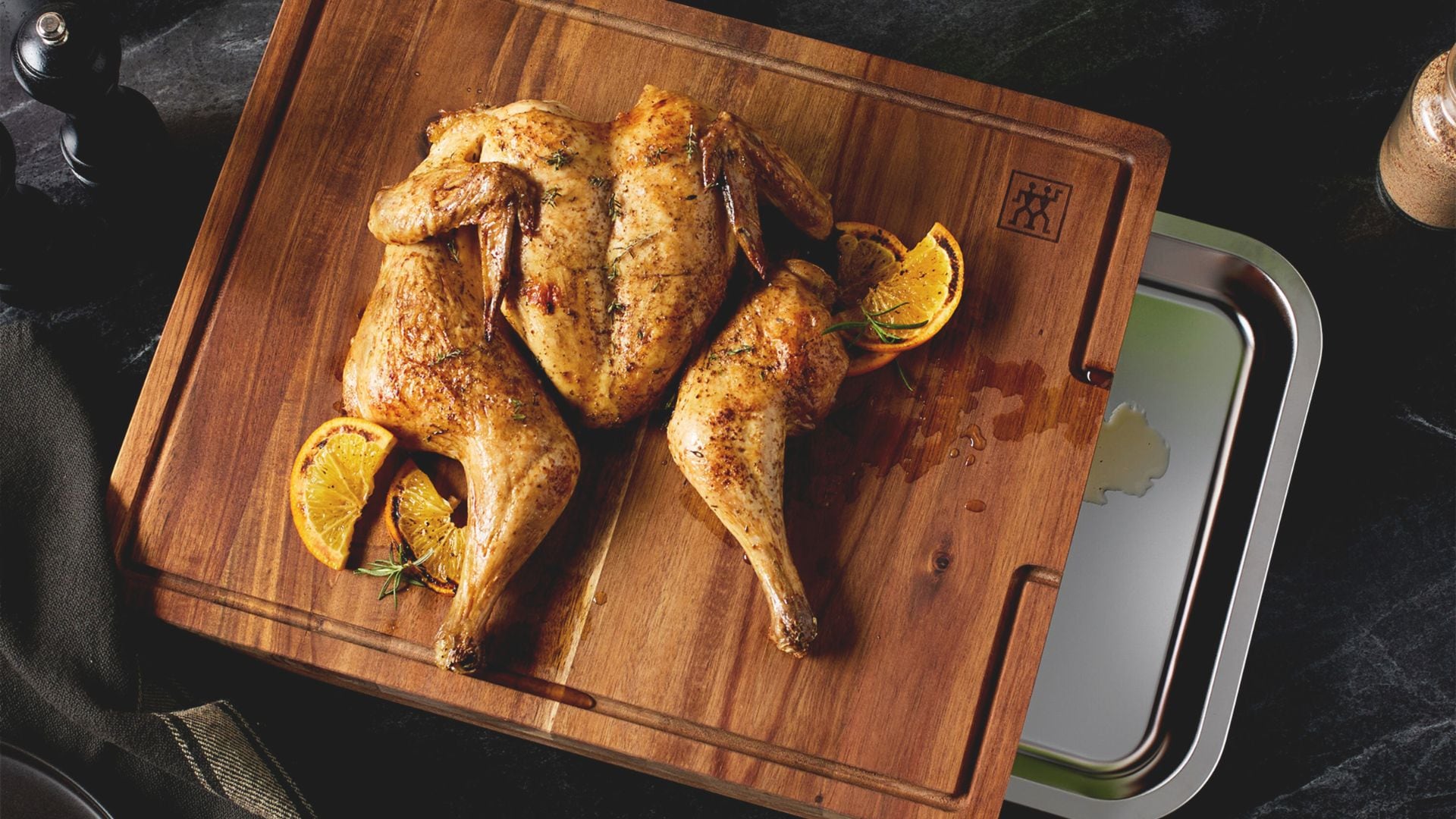 A Zwilling cutting board with a chicken on it.