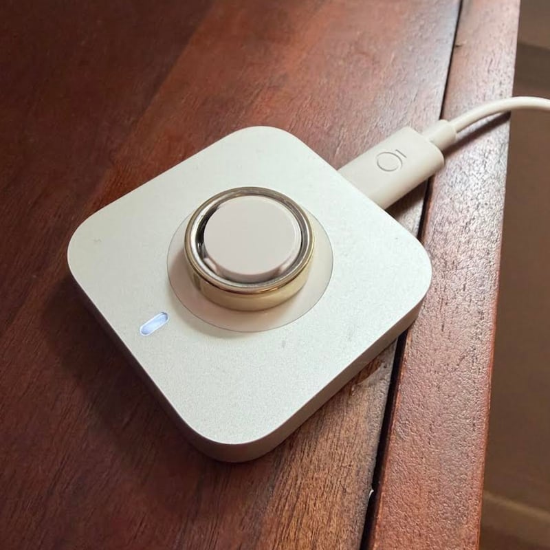 The OURA Ring 5 on its charger