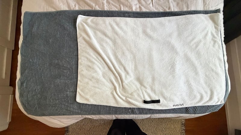 An Everist hair towel on a bed.