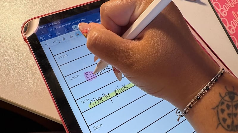 Bianca using the ESR Geo Digital iPad Pencil to write in her digital planner