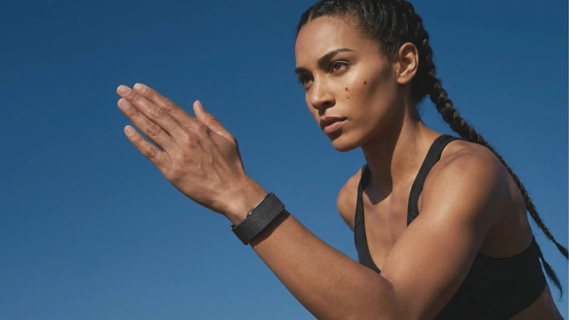 A person running while wearing a Hume Band 2.0.