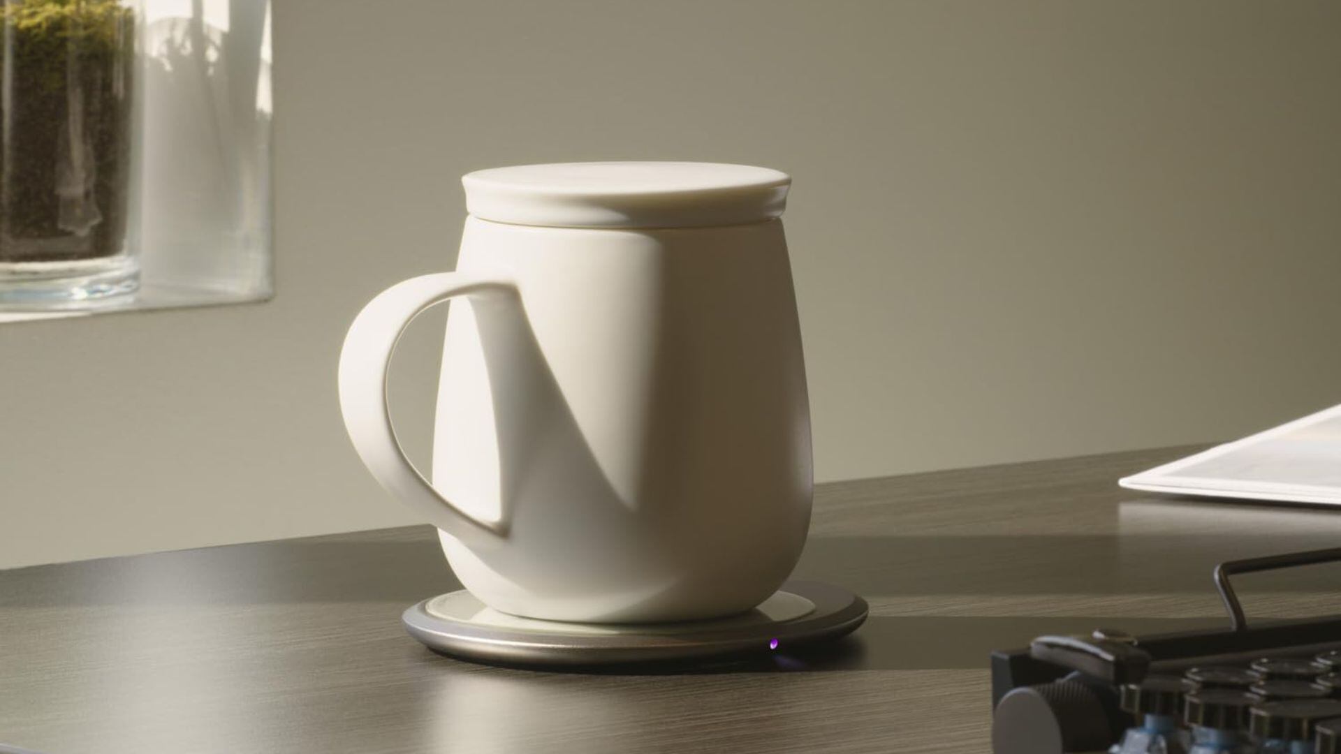 A temperature-controlled mug on a desk.
