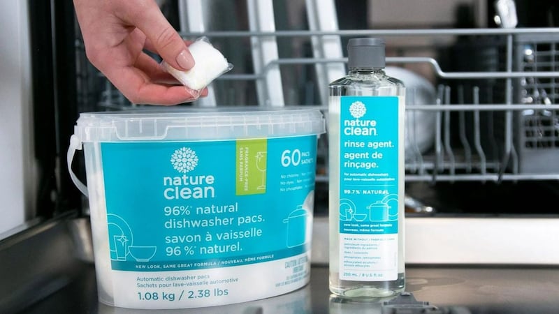 a person reaching for a dishwasher cleaning pod