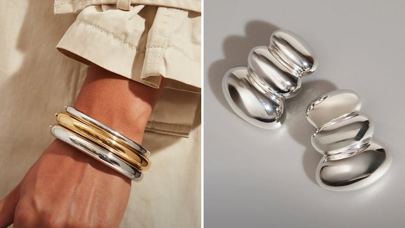 A person wearing three Jenny Bird bracelets and a pair of Jenny Bird earrings.