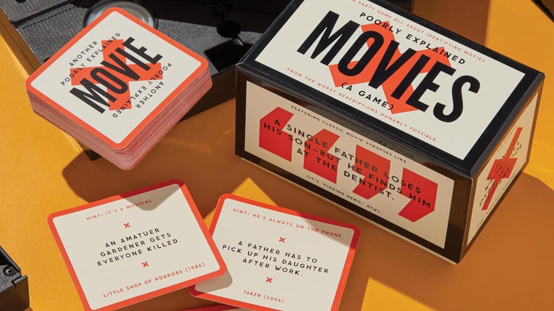A movie guessing game is laid out on a table.