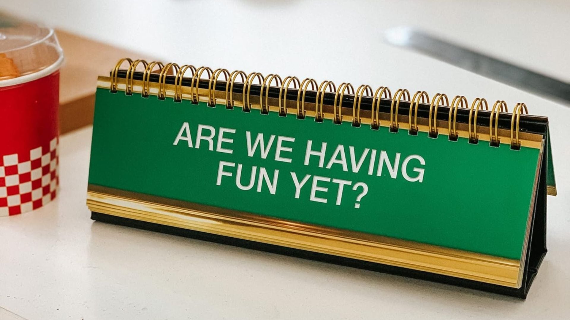 a desk plaque that says are we having fun yet