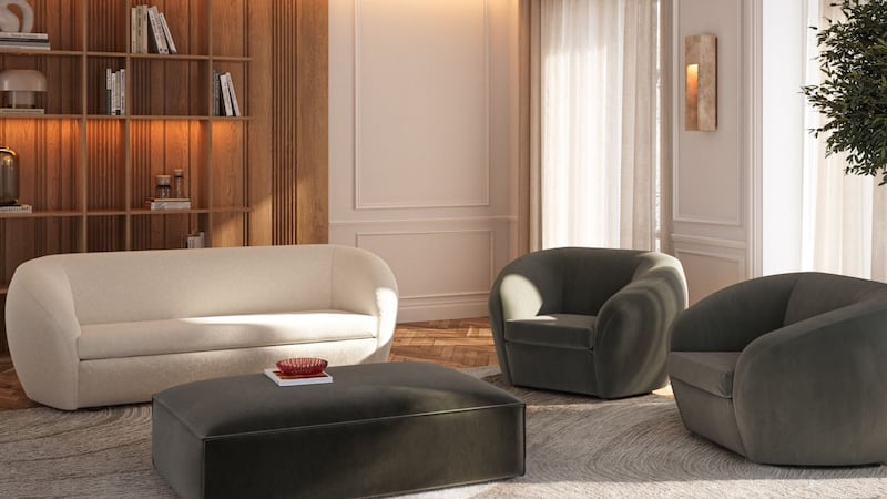 a sofa and two chairs in a living room