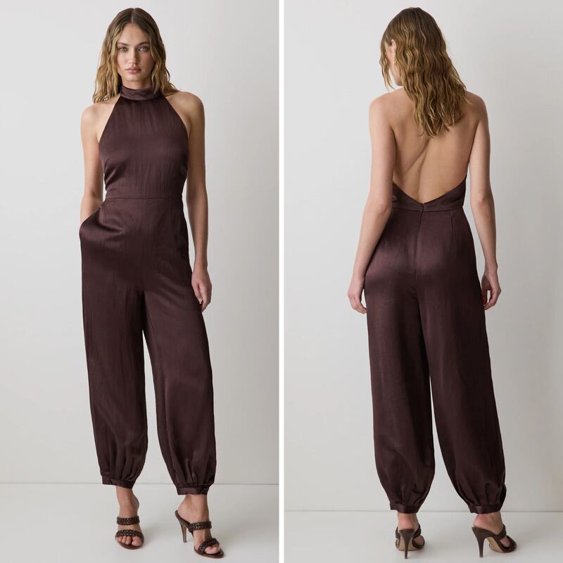 A person wearing a satin jumpsuit from RW&CO.