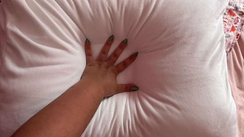 Bianca squishing her hand into the pillow