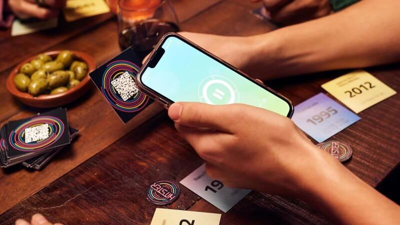 The game DJ scanning a QR code on the back of a song card