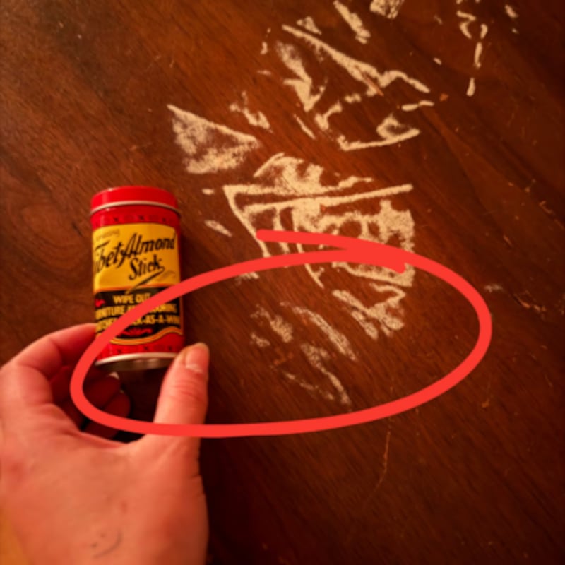 Marie-Pier showing the Tibet Almond Stick next to scratches on wooden floor