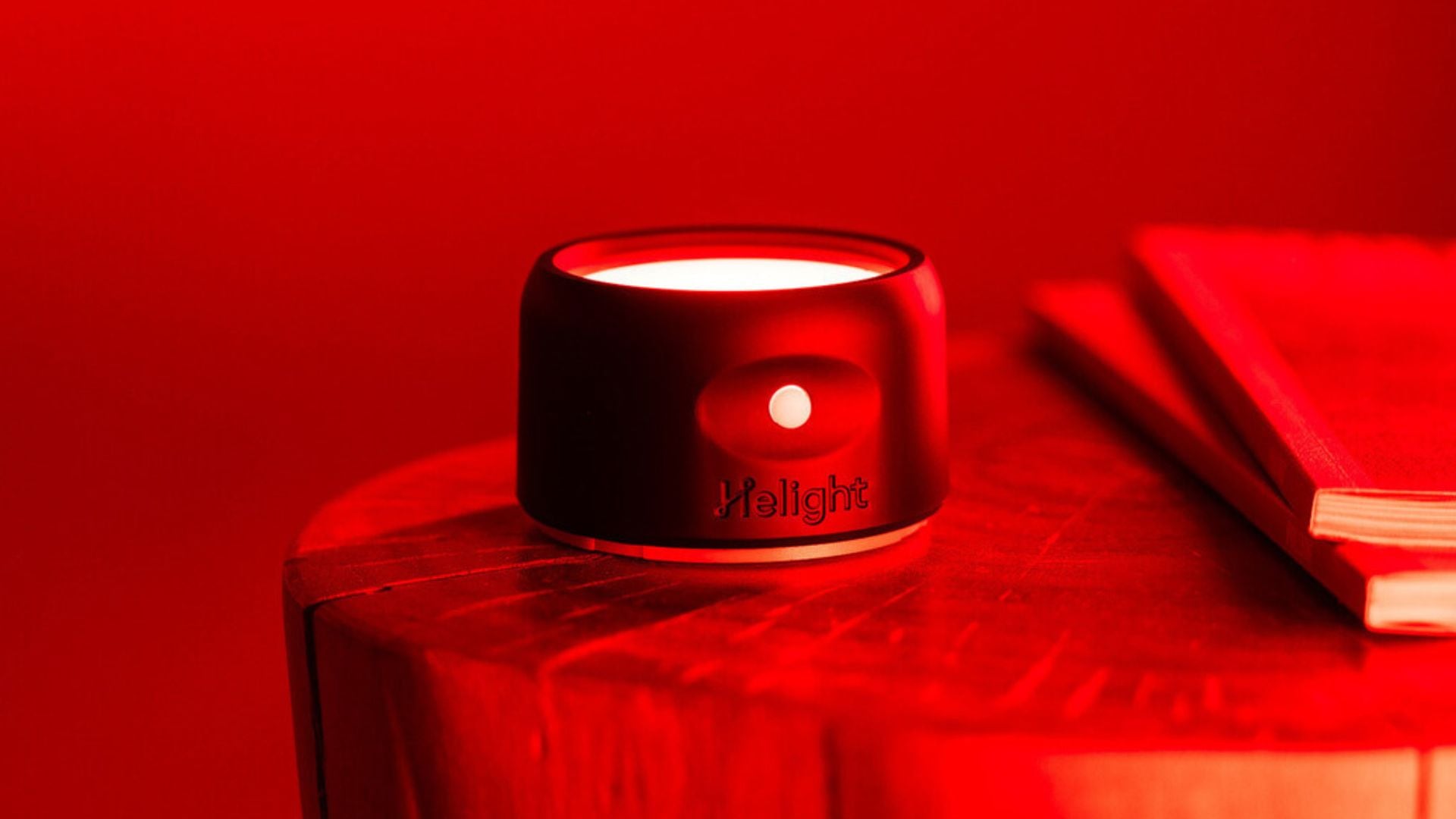 A Therapy Light on a wooden bedside table.