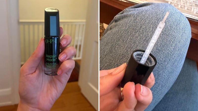 Alice holding a bottle of OPI Repair Mode and showing the brush.