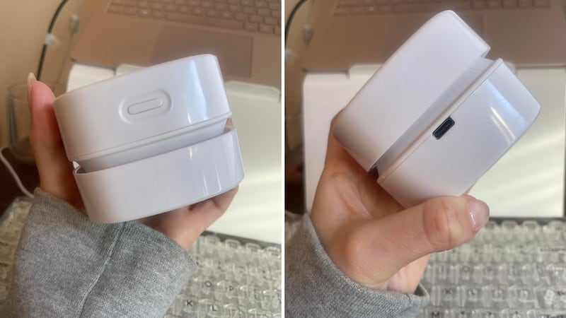 Alice is holding the handheld vacuum to show the power button and USB port.