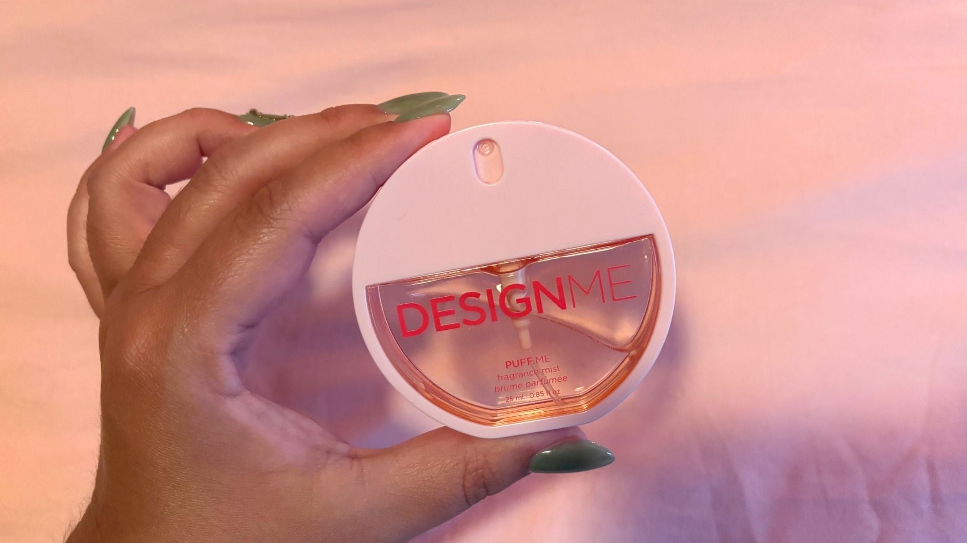 Bianca holding the fragrance with a light plain background
