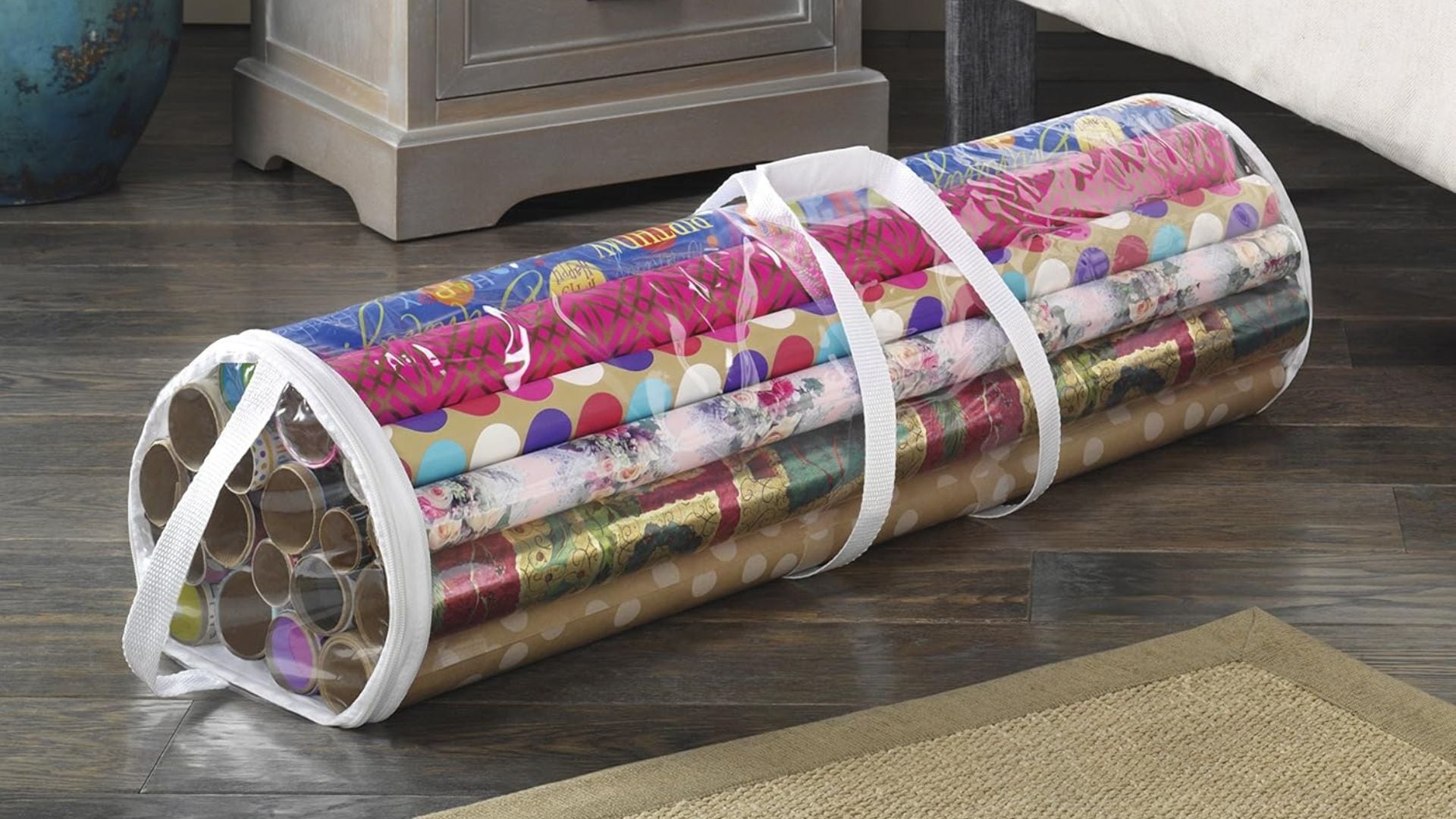 a wrapping paper organizer next to a bed