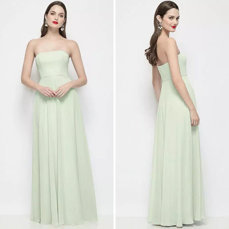 A person wearing a light green Dessy bridesmaid dress.
