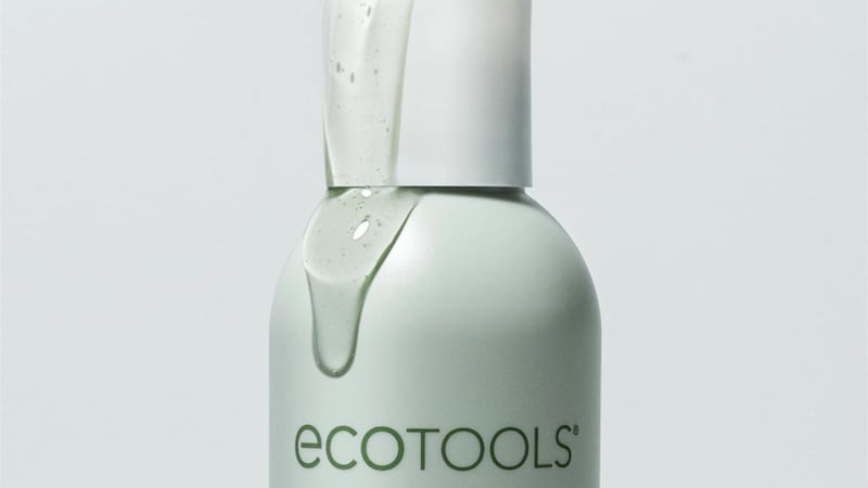 A bottle of the product with cleanser coming out of the lid.