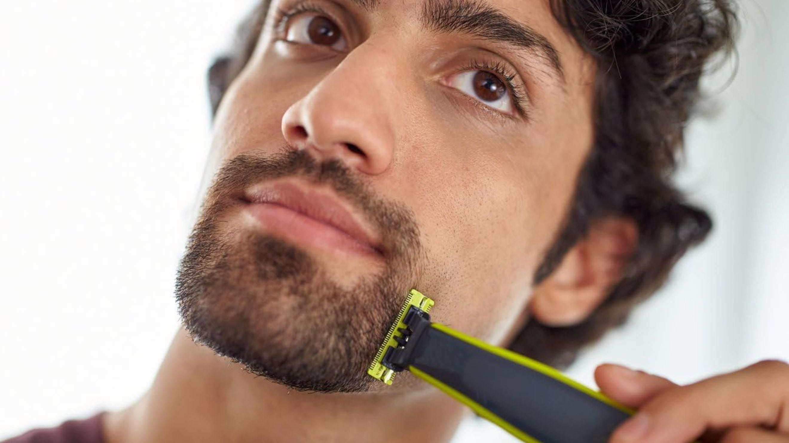 A person shaving their beard.