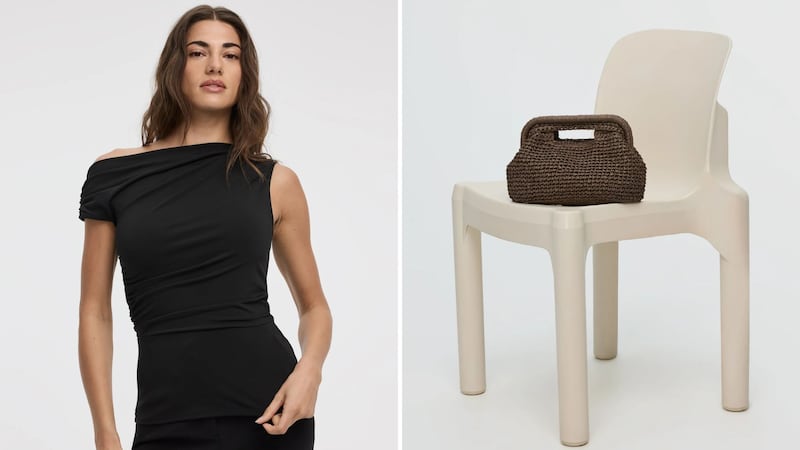 A person wearing a Reitmans top and a straw bag on a chair.