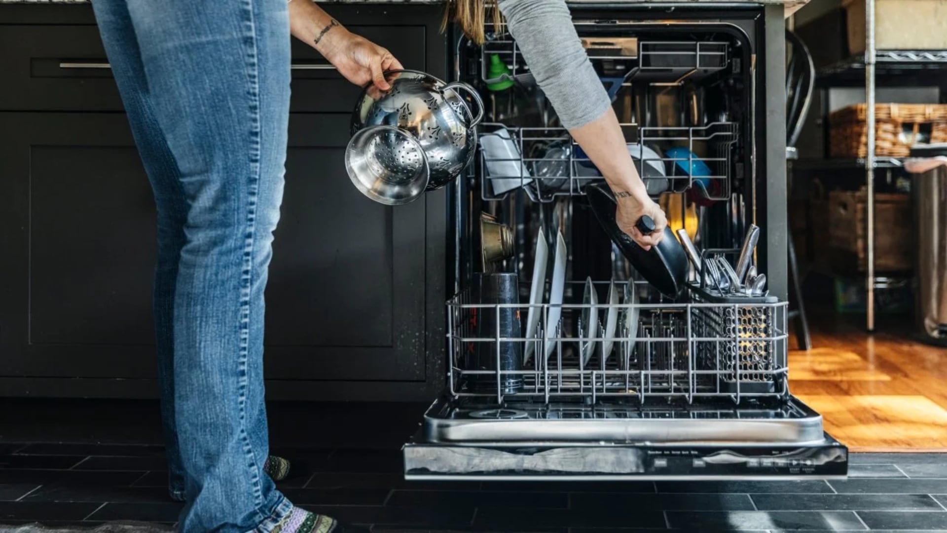 Person loading a dishwasher