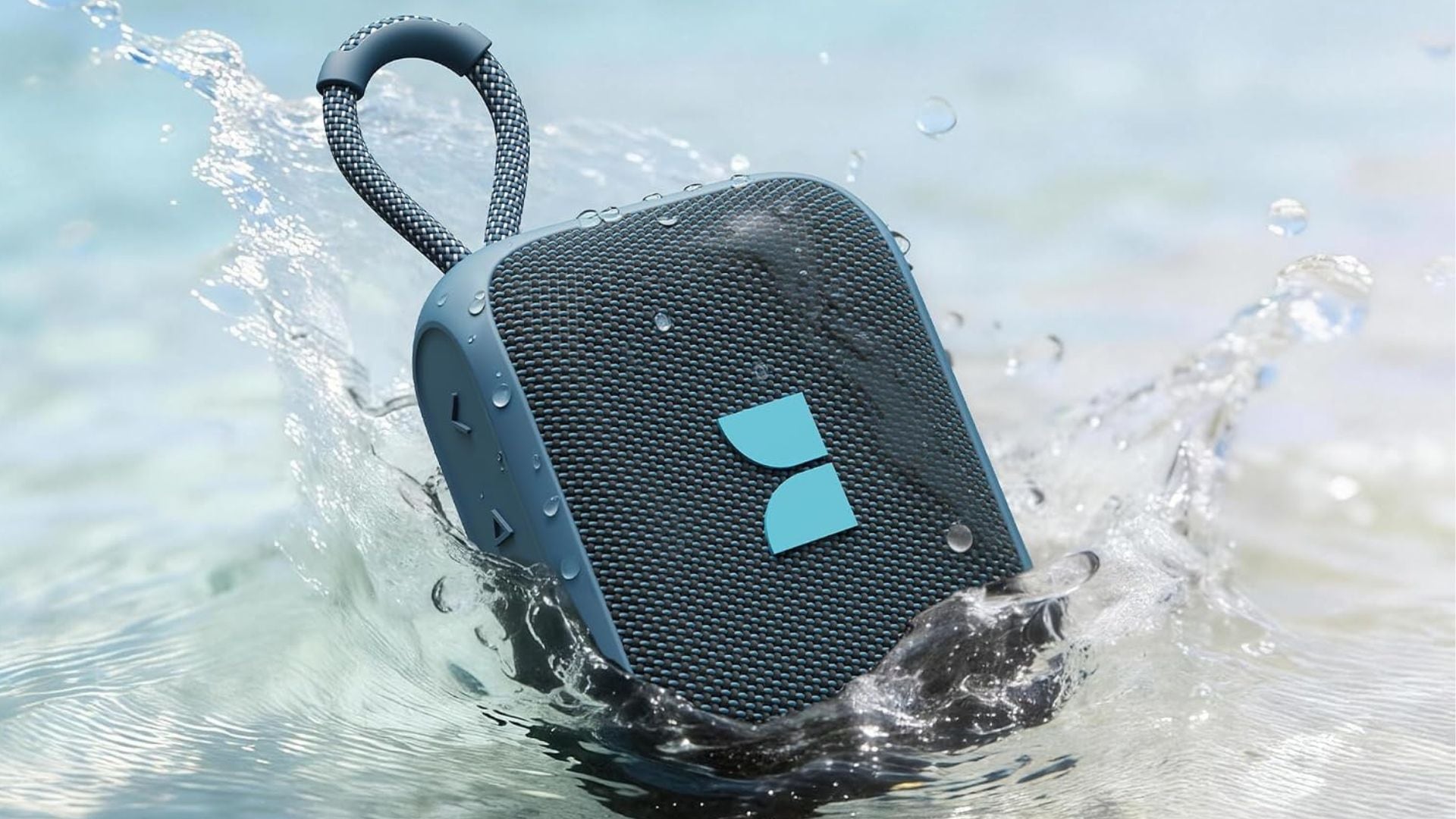 A Monster Bluetooth speaker splashing into a body of water.